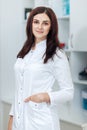 Female brunette cosmetologist in uniform in the cosmetology office