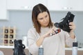 Female with brush cleaning black leather shoe Royalty Free Stock Photo