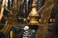 A female Buddhist offering flowers to the golden stupa Royalty Free Stock Photo