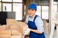 Female builder carrying hollow clay bricks and putting them on brick stack