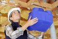 Female builder installing ventilation pipes