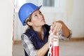 female builder putting up safety chain Royalty Free Stock Photo
