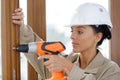 Female builder using cordless screwdriver Royalty Free Stock Photo