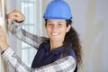 Female builder using wallpaper scraper Royalty Free Stock Photo
