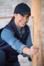 female builder working with wood framework