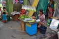 A female Burmese vendor selling cut fresh raw mango