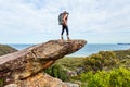 Hiker on rock cliff precipice with views