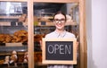 Female business owner holding OPEN sign Royalty Free Stock Photo