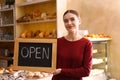 Female business owner holding OPEN sign Royalty Free Stock Photo