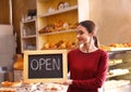 Female business owner holding OPEN sign Royalty Free Stock Photo