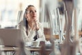 Female business owner prays in a closed restaurant for better times and the end of coronavirus pandemic