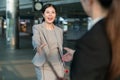 Female business people greeting in a station.