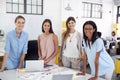 Female business team stand at office desk looking to camera Royalty Free Stock Photo