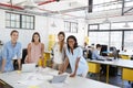 Female business team stand at office desk looking to camera Royalty Free Stock Photo