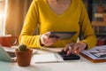 Female businessman working on desk office with using a calculator to calculate. Royalty Free Stock Photo