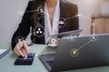 Female businessman working with holding a pen and using a calculator to calculate the numbers of static at home office. Finance Royalty Free Stock Photo