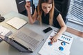 Female businesswoman readind financial report analyzing statistics pointing at pie chart working at her desk Royalty Free Stock Photo