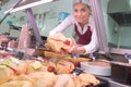 Female butcher holding raw chicken Royalty Free Stock Photo