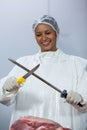 Female butcher sharpening her knife