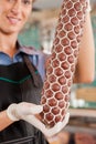 Female Butcher Showing Fresh Sausage Royalty Free Stock Photo
