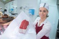 female butcher showing joint lean beef