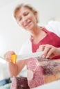 Female butcher slicing beef