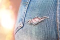 Female Buttock in Slim Blue Denim Jeans with Ripped Hole. Celebration Party Lights