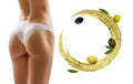 Female buttocks near swirl olive oil. Slimming and dieting concept. Royalty Free Stock Photo