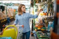 Female buyer with cart in shop for gardeners