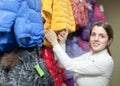 Female buyer chooses the winter jacket Royalty Free Stock Photo