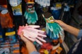 Female buyer choosing gloves, shop for floristry