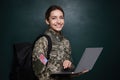 Female cadet with backpack and laptop near chalkboard. Military education Royalty Free Stock Photo
