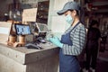 Female cafe worker checking online orders indoors