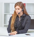 Female call center service operator at work. Royalty Free Stock Photo