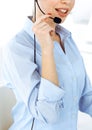 Female call operator is using computer and headset for consulting clients online, close-up. Group of diverse people Royalty Free Stock Photo
