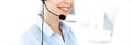 Female call operator is using computer and headset for consulting clients online, close-up. Group of diverse people Royalty Free Stock Photo