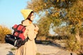 Female camper with backpack and sleeping bag in wilderness. Royalty Free Stock Photo