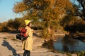 Female camper with backpack and sleeping bag in wilderness. Royalty Free Stock Photo