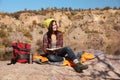 Female camper reading book while sitting on sleeping bag Royalty Free Stock Photo