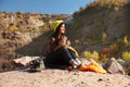 Female camper with thermos sitting on sleeping bag Royalty Free Stock Photo