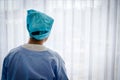 A female cancer patient sat sadly in bed, looking at the window.