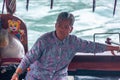 Female captain on taxi sloop on Aberdeen Harbour, Hong Kong, China