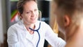 Female cardiologist conducts medical examination of her patient in medical clinic. Royalty Free Stock Photo