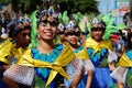 Female carnival dancer in ethnic costumes dances in delight along the road