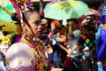Female carnival dancer in ethnic costumes grimaces under sun heat