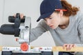 Female carpenter cutting wood with circular power saw Royalty Free Stock Photo