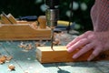 Female carpenter drilling wooden plank to make hole, close-up view. DIY, woodwork concept Royalty Free Stock Photo