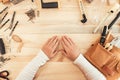 Female carpenter hands on work desk, top view