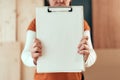 Female carpenter holding clipboard note pad paper mock up