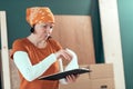 Female carpenter reading DIY project notes